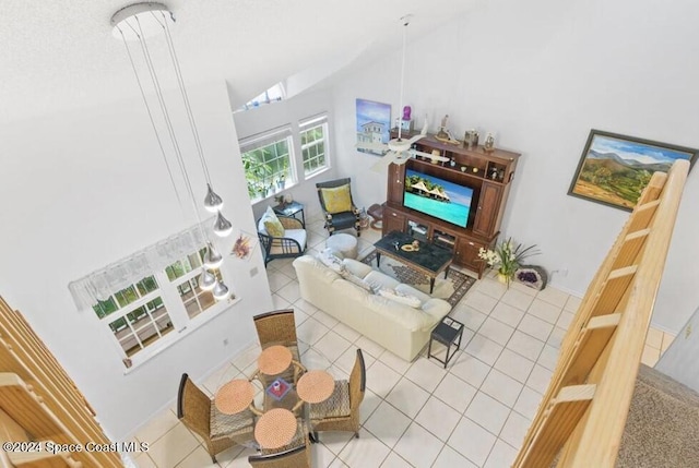 living room with tile patterned flooring and a towering ceiling