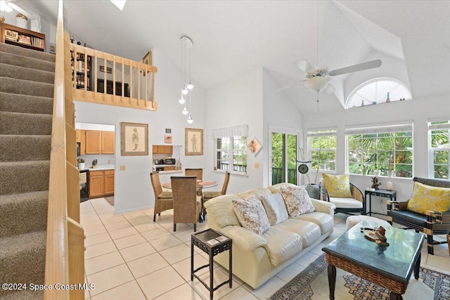 living room featuring ceiling fan, light tile patterned floors, and high vaulted ceiling
