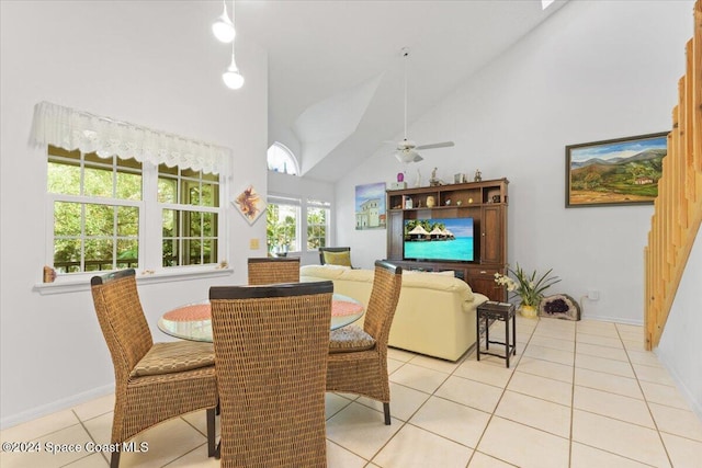 dining area featuring ceiling fan, high vaulted ceiling, and light tile patterned floors