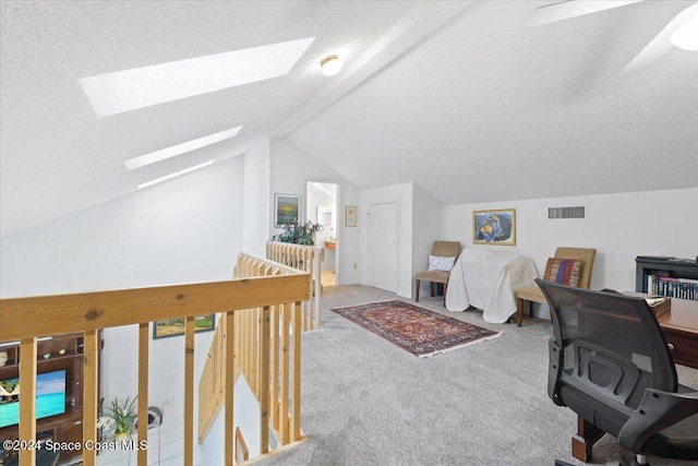 carpeted office space with lofted ceiling with skylight and a textured ceiling