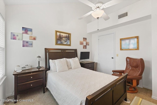 bedroom with ceiling fan and light carpet