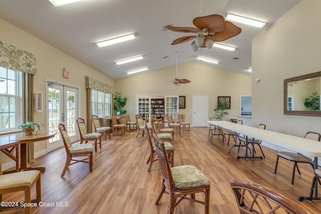 dining space featuring french doors, light hardwood / wood-style flooring, ceiling fan, and lofted ceiling