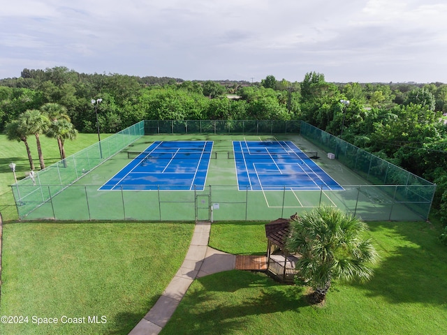 view of sport court featuring a yard