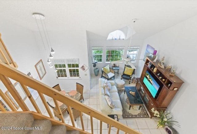 tiled living room featuring a notable chandelier