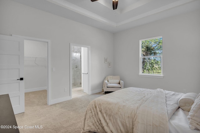 carpeted bedroom featuring ceiling fan, a closet, a spacious closet, and ensuite bath