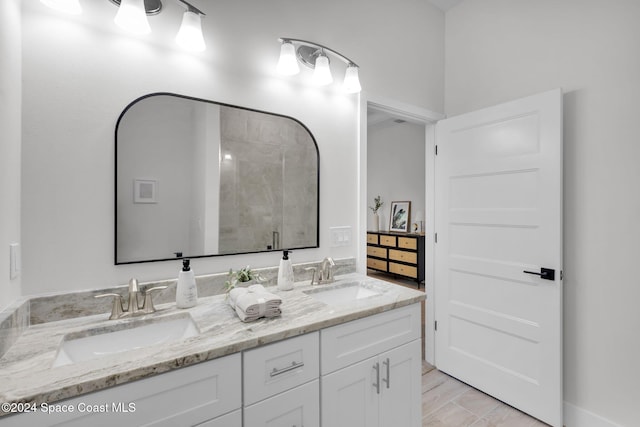 bathroom with vanity and a shower with shower door