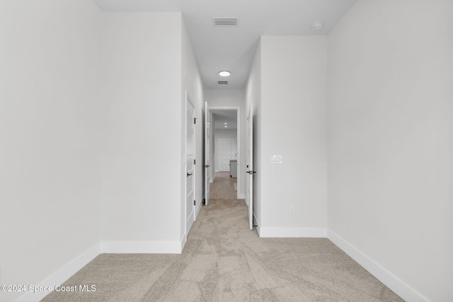 hallway with light colored carpet