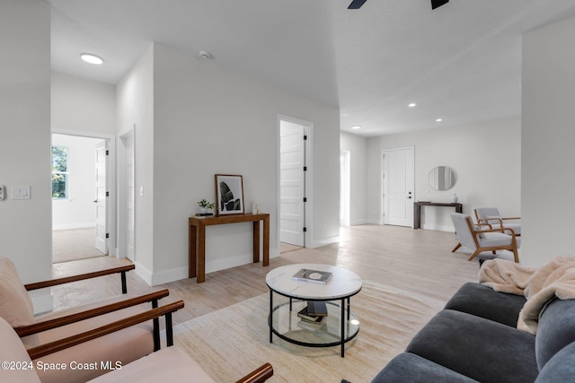 living room featuring ceiling fan and light hardwood / wood-style flooring