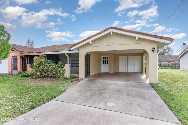 view of front facade with a front yard and a carport