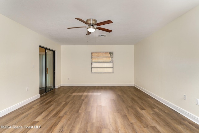 spare room featuring ceiling fan, wood-type flooring, and a textured ceiling