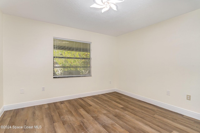 unfurnished room featuring hardwood / wood-style floors and a textured ceiling