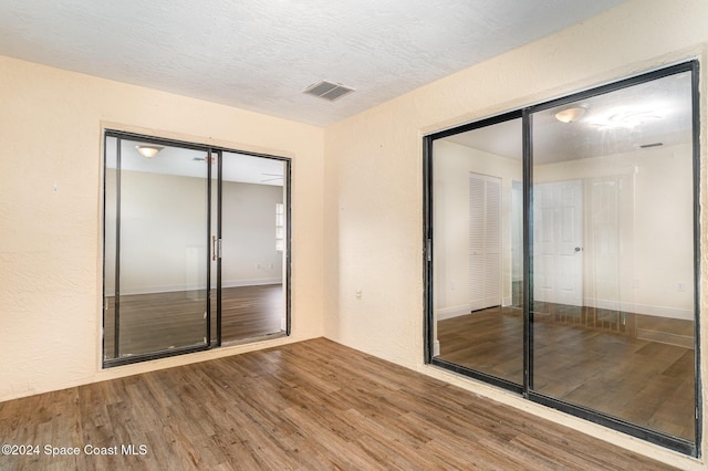 spare room featuring wood-type flooring