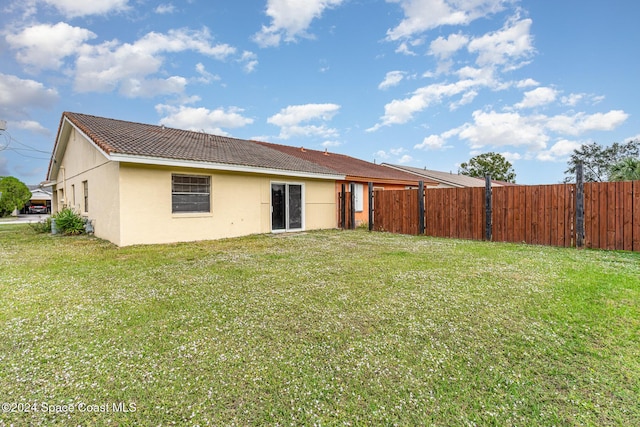 rear view of house with a lawn