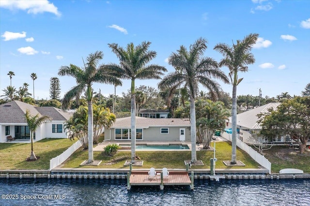 rear view of house featuring a yard, a water view, and a patio