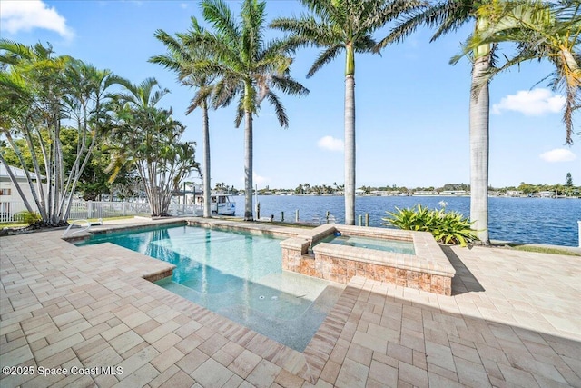 view of pool featuring a water view, a patio, and an in ground hot tub