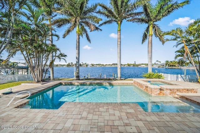 view of pool featuring an in ground hot tub and a water view