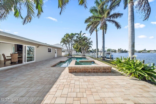 view of swimming pool with a water view, a patio area, and an in ground hot tub