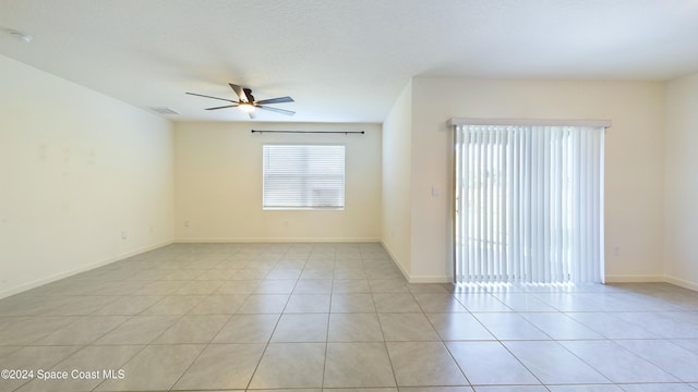 empty room featuring ceiling fan and light tile patterned flooring