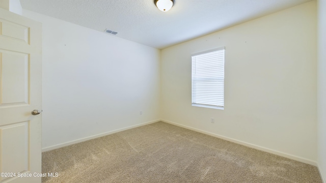 spare room with light colored carpet