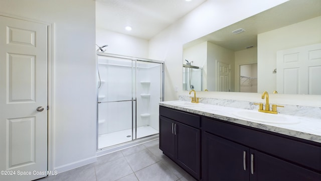 bathroom with tile patterned flooring, vanity, and an enclosed shower