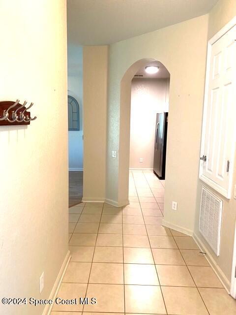 corridor with light tile patterned flooring