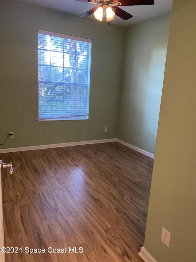 unfurnished room featuring dark hardwood / wood-style floors and ceiling fan