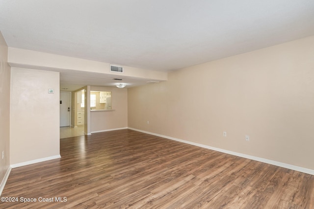 unfurnished room with hardwood / wood-style flooring