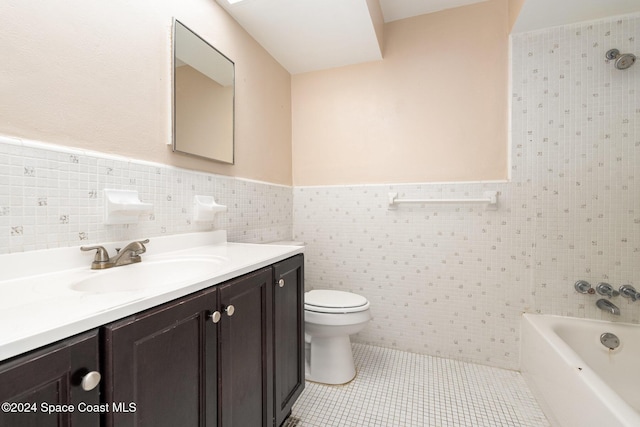 bathroom with tile patterned flooring, vanity, a bath, and tile walls