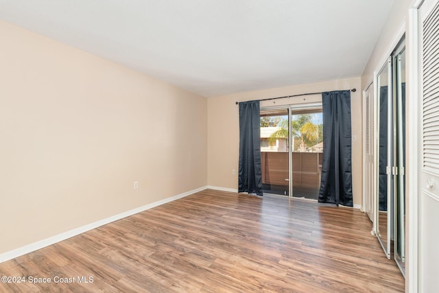 empty room with hardwood / wood-style floors