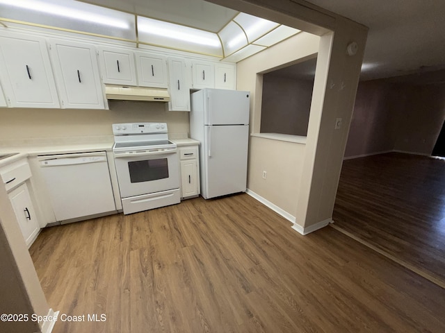 kitchen with white cabinets, white appliances, and light hardwood / wood-style floors