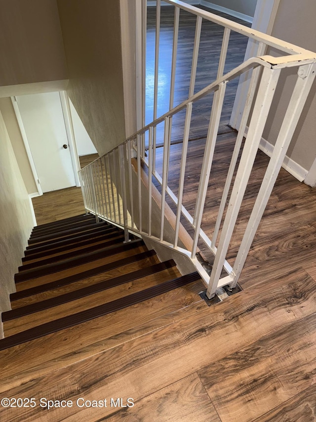 stairway featuring wood-type flooring