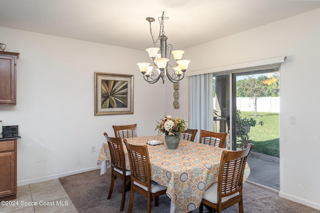 tiled dining room with a chandelier