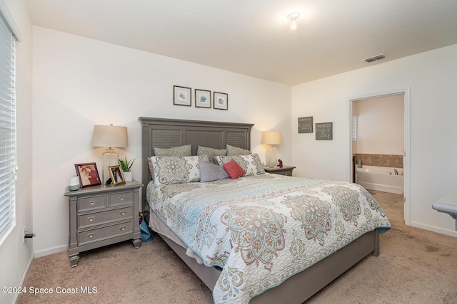 carpeted bedroom with ensuite bathroom