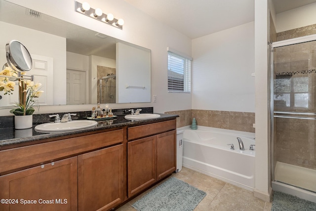 bathroom with tile patterned floors, vanity, and independent shower and bath