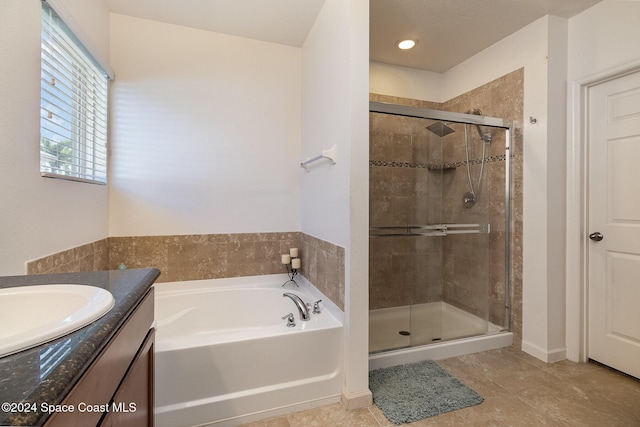 bathroom with tile patterned floors, vanity, and separate shower and tub