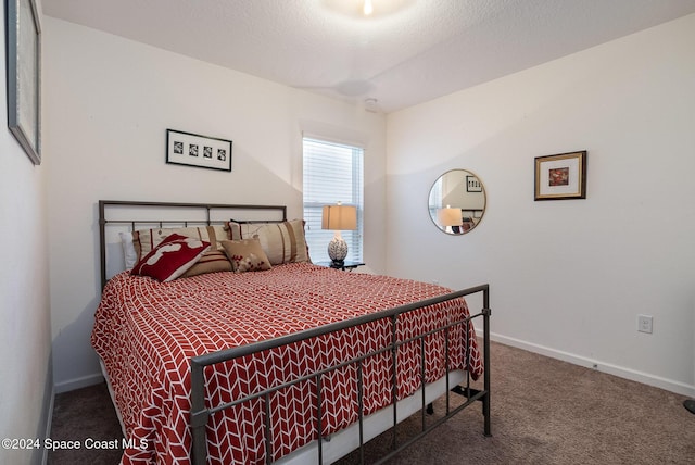 bedroom with carpet flooring and a textured ceiling