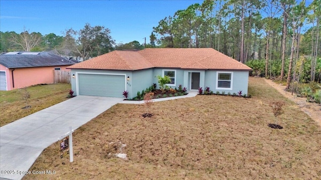 single story home with a garage and a front lawn