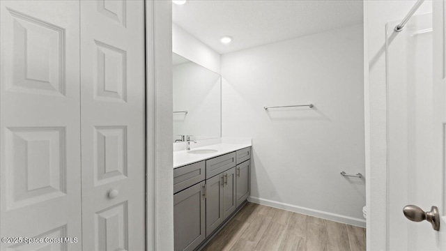 bathroom featuring vanity, hardwood / wood-style floors, and toilet