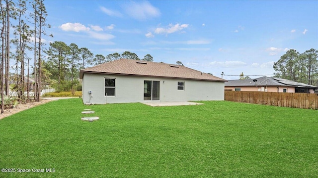 back of house featuring a patio and a yard