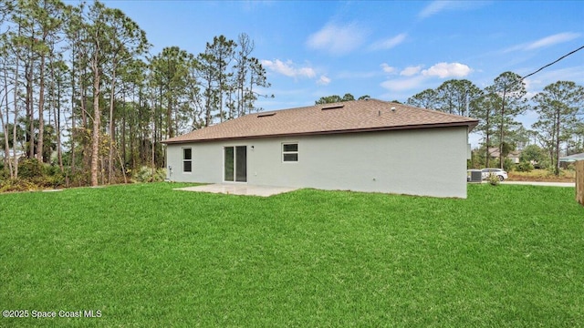 back of property with a patio area and a lawn