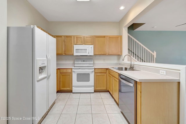 kitchen featuring sink, white appliances, light brown cabinets, and light tile patterned flooring