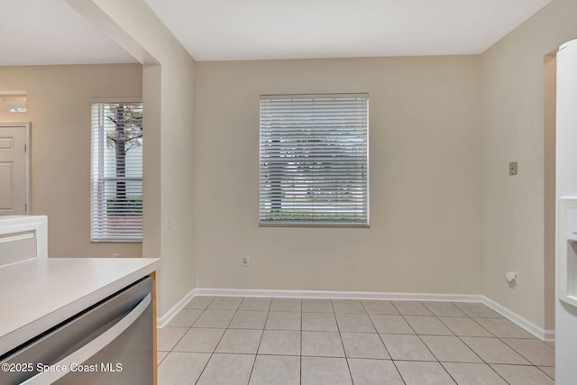 unfurnished dining area featuring light tile patterned floors