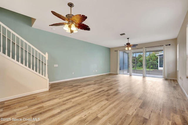 unfurnished living room featuring ceiling fan and light wood-type flooring