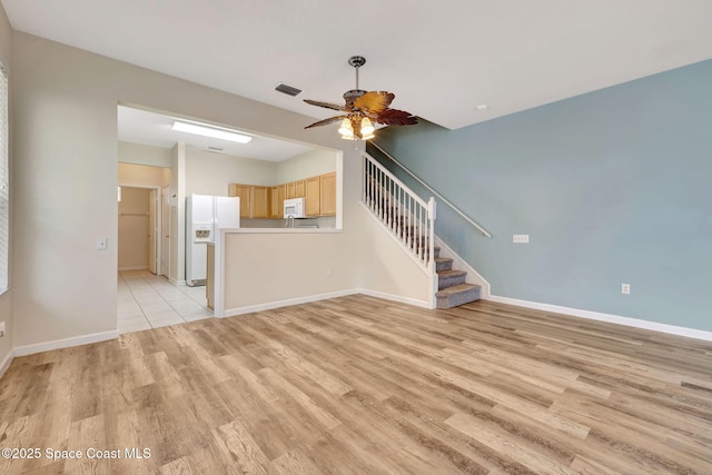 unfurnished living room with light hardwood / wood-style floors and ceiling fan