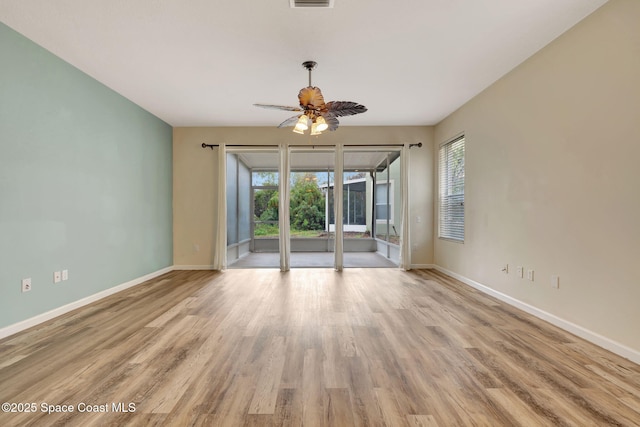 unfurnished room featuring ceiling fan, light hardwood / wood-style floors, and a wealth of natural light