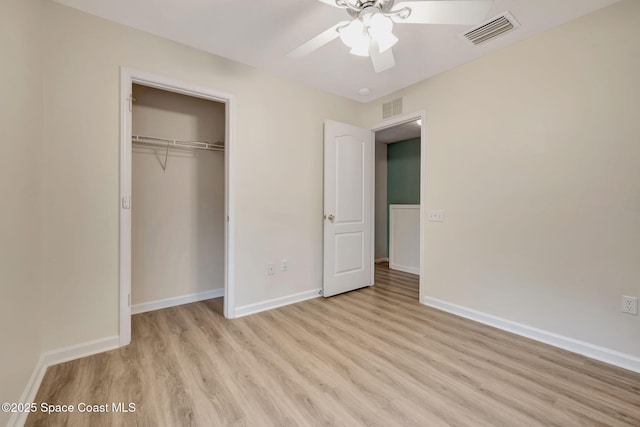 unfurnished bedroom featuring ceiling fan, light hardwood / wood-style floors, and a closet