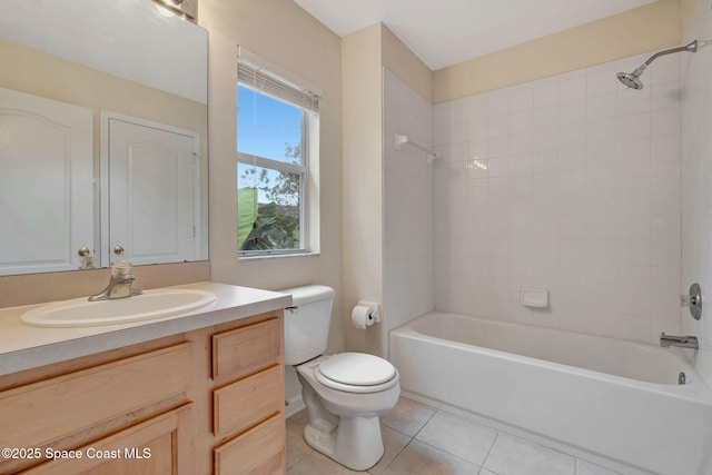 full bathroom with tile patterned floors, toilet, vanity, and tiled shower / bath combo