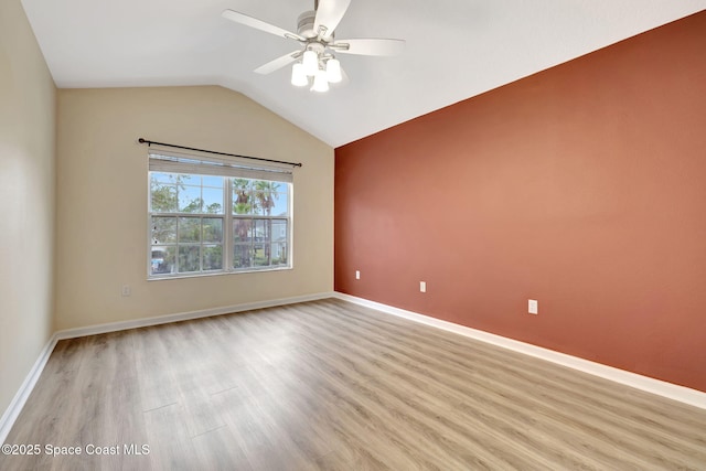 unfurnished room featuring light hardwood / wood-style floors, vaulted ceiling, and ceiling fan