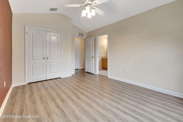 unfurnished bedroom with ceiling fan, light hardwood / wood-style floors, ensuite bathroom, and a closet