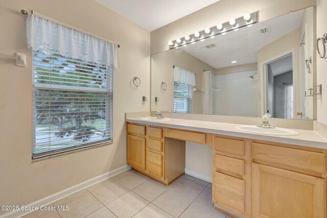 bathroom featuring vanity, walk in shower, and tile patterned flooring